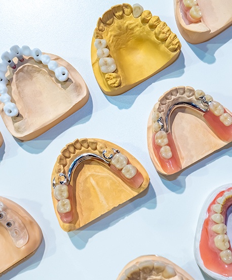 Various types of dentures against a blue background