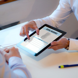 Patient reviewing dental insurance form on tablet