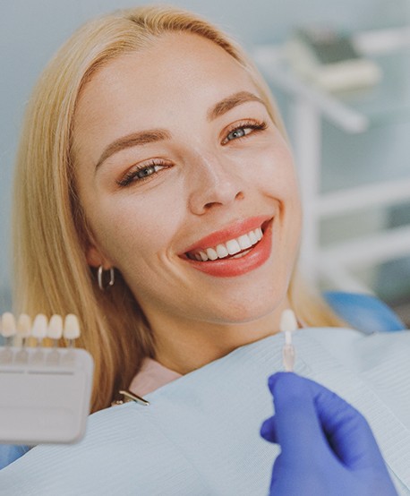 A woman smiling after getting veneers