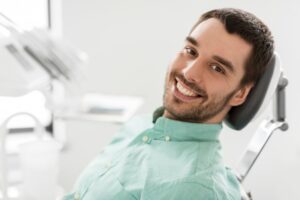Man smiling while in his dentist's treatment chair